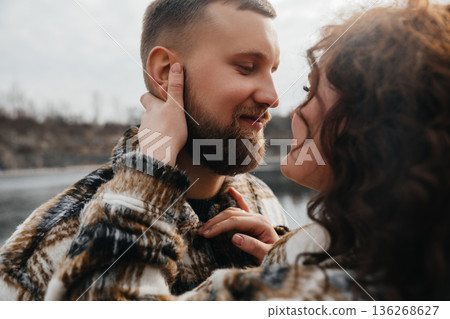 Couple shares a moment of love by the water on Valentines Day near a scenic landscape 136268627