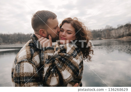 Couple shares a romantic moment by the water on Valentines Day while enjoying their connection and love Couple shares a romantic moment by the water on Valentines Day while enjoying their connection and love 136268629