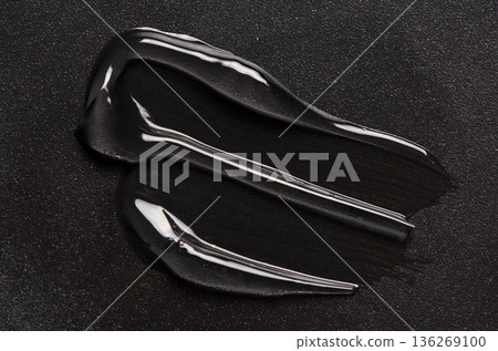 A moisturizer or body gel or a facial serum. Black background. 136269100