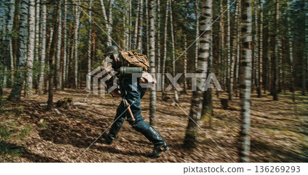German soldier running through birch forest with motion blur effect 136269293