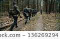 German soldiers marching in forest formation during WWII reenactment German soldiers marching in forest formation during WWII reenactment 136269294