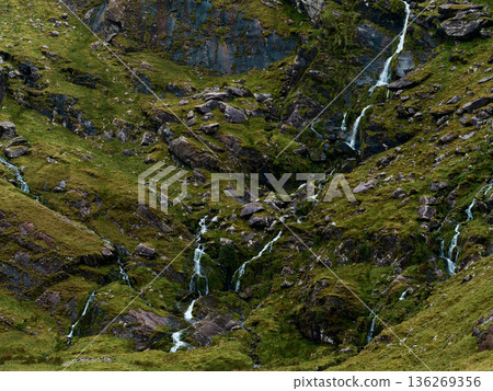 Natures artwork, water carving through green and stone. 136269356