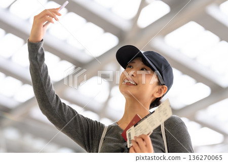 A woman taking a selfie at the airport. Photo courtesy of Kansai International Airport (KIX). A woman taking a selfie at the airport. Photo courtesy of Kansai International Airport (KIX). 136270065