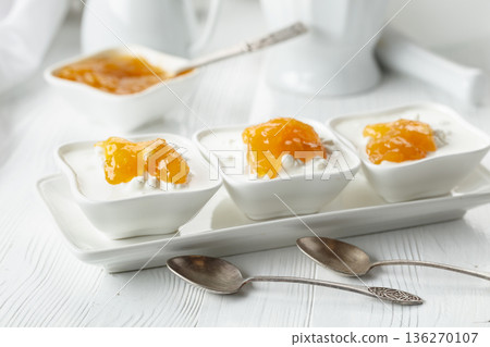 Cottage cheese with cream and yellow jam. 136270107