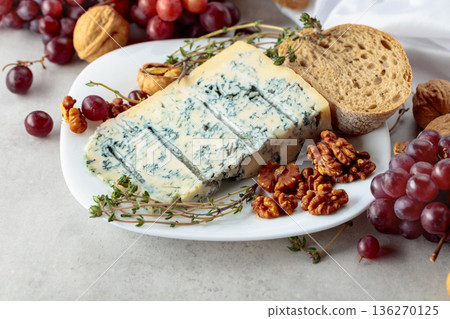 Gorgonzola cheese with walnuts, red grapes, and thyme. 136270125