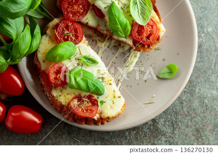 Hot open sandwiches with mozzarella, tomatoes and basil. Hot open sandwiches with mozzarella, tomatoes and basil. 136270130