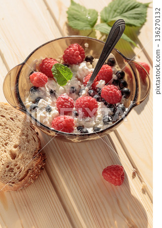 Cottage cheese with fresh raspberries and  blueberries. 136270132