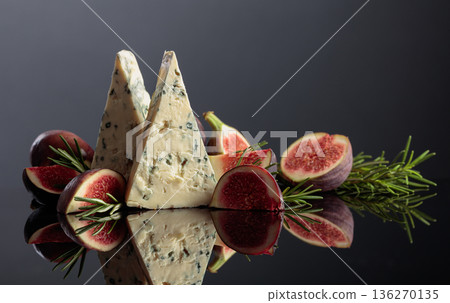 Blue cheese with fresh figs and rosemary on a black background. Blue cheese with fresh figs and rosemary on a black background. 136270135