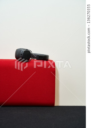 Black Headphones Resting on Red Fabric Black Headphones Resting on Red Fabric 136270355
