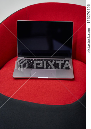 Laptop on Modern Red Cushion Laptop on Modern Red Cushion 136270396