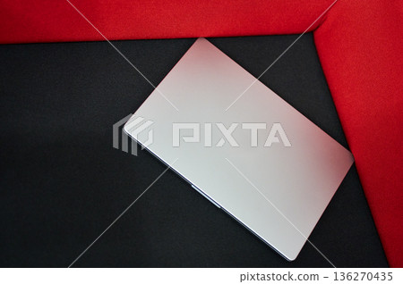 Laptop on Red Velvet Background - Modern Workspace Laptop on Red Velvet Background - Modern Workspace 136270435