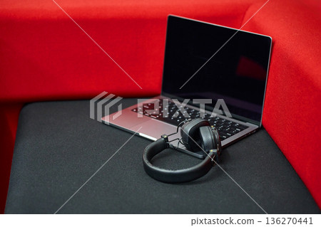 Laptop with Headphones on Red Cushion 136270441