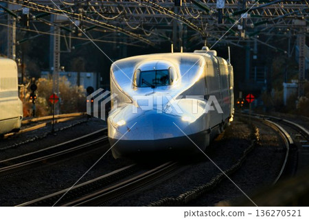 The N700A series train runs along Japan's main artery, the Tokaido Shinkansen, at Odawara Station The N700A series train runs along Japan's main artery, the Tokaido Shinkansen, at Odawara Station 136270521