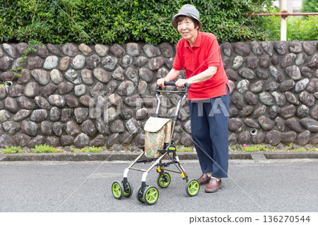 Senior woman walking on the road using a silver cart outdoors, pushcart, whole body Senior woman walking on the road using a silver cart outdoors, pushcart, whole body 136270544