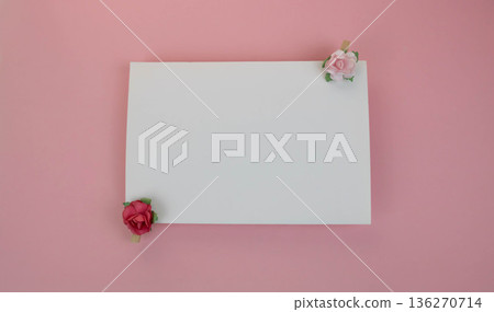 A sheet of white paper for notes with wooden clothespins with red and pink flowers on a pink background. Space for your text. Concept of a holiday, birthday, March 8, Valentine's Day. 136270714