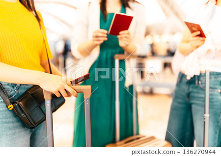 Women checking documents at the airport ■Photography provided by Kansai International Airport (KIX) Women checking documents at the airport ■Photography provided by Kansai International Airport (KIX) 136270944