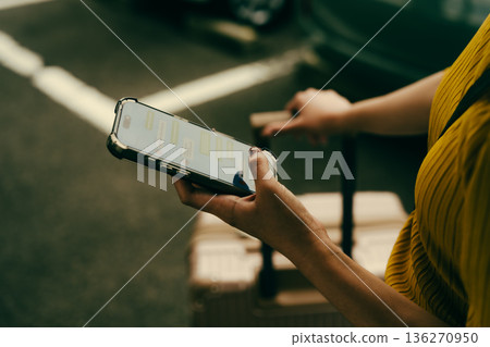 一名女子在戶外使用智慧型手機。照片由關西國際機場（KIX）提供。 136270950