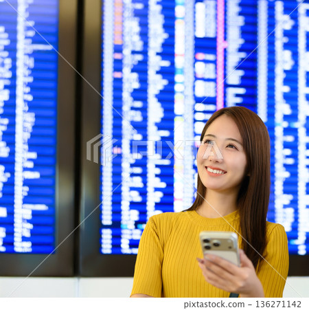 A woman looking at an information board at the airport. Photo courtesy of Kansai International Airport (KIX). 136271142
