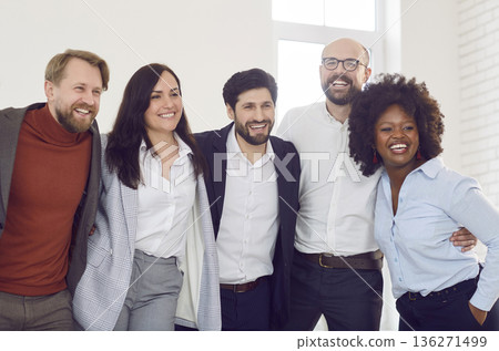 Group of business colleagues with smiles and hugs showing teamwork spirit and diversity in office. Group of business colleagues with smiles and hugs showing teamwork spirit and diversity in office. 136271499