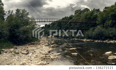 Suspension Bridge Over Mountain River in Forest Landscape Suspension Bridge Over Mountain River in Forest Landscape 136271515