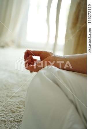 Hand in Meditation Pose on Soft Carpet 136272119