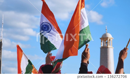 Hands holding waving Indian flags celebrating patriotism and national identity Hands holding waving Indian flags celebrating patriotism and national identity 136272706