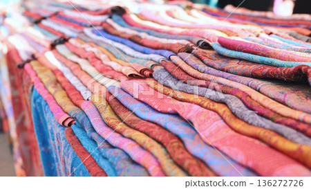 India market stall displaying colorful pashmina textiles and traditional patterned fabrics 136272726