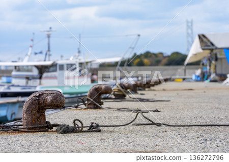 Mooring bollards and ropes connecting ships in the harbor Mooring bollards and ropes connecting ships in the harbor 136272796