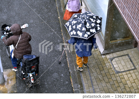 Yokohama cityscape in Japan. Freezing cold with powdery snow falling... steps and uneven terrain... aging society. Elderly woman with a walking stick = Yokohama city 136272807