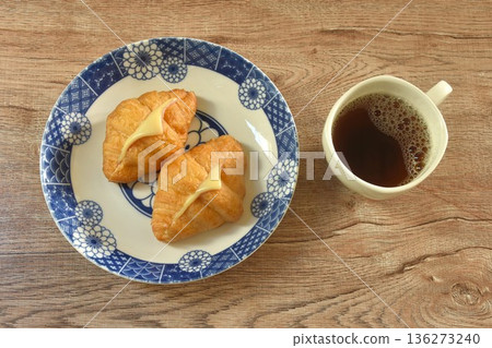 baking crispy butter croissant French bread stuffed ham cheese on plate eat with black hot coffee cup baking crispy butter croissant French bread stuffed ham cheese on plate eat with black hot coffee cup 136273240