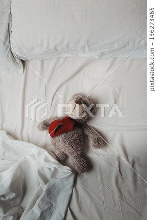 Teddy bear on bed in the morning Teddy bear on bed in the morning 136273465