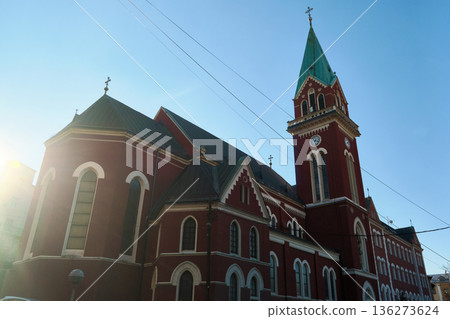 Red brick church with tall bell tower in European city Red brick church with tall bell tower in European city 136273624