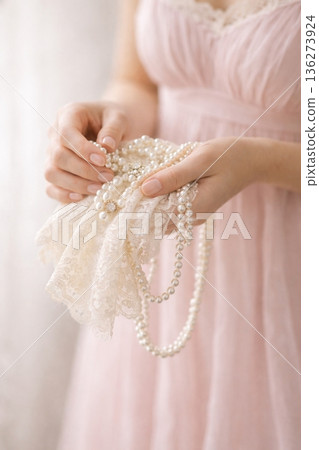 Elegant Woman in Lavender Dress Handling Pearl Jewelry and Lace Elegant Woman in Lavender Dress Handling Pearl Jewelry and Lace 136273924