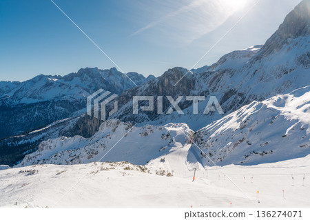 Skiers enjoy a sunny winter day on slopes in the Bavarian Alps 136274071