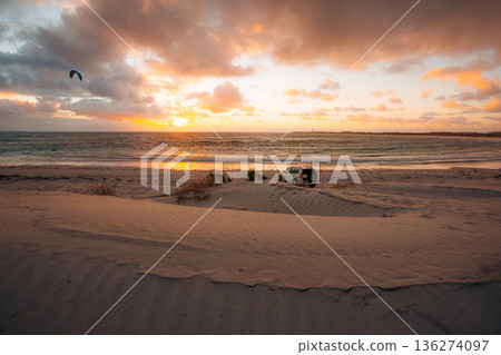 Kitesurfer and SUV on a beach at sunset in Australia Kitesurfer and SUV on a beach at sunset in Australia 136274097