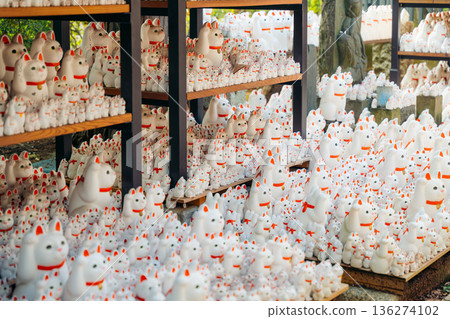 Maneki neko statues at a Japanese temple in Tokyo, Japan, offering good fortune Maneki neko statues at a Japanese temple in Tokyo, Japan, offering good fortune 136274102