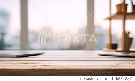 A simple wooden desk with window light streaming in 136274287