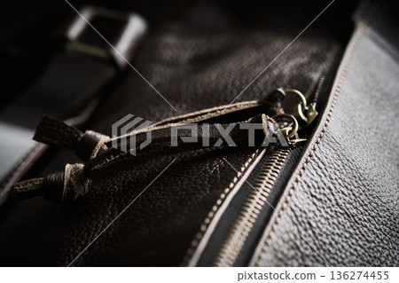 Leather bag zipper and strap detail in low light 136274455