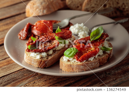 Ciabatta with sun dried tomatoes in olive oil, creamy cheese, and basil. Ciabatta with sun dried tomatoes in olive oil, creamy cheese, and basil. 136274549
