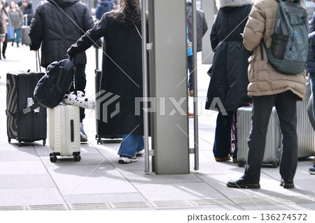 Tokyo cityscape in Japan. Suitcases.... Tokyo Station Marunouchi Square bustling with foreign tourists 136274572