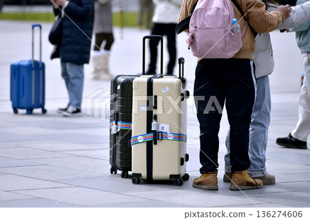 Tokyo cityscape in Japan. Suitcases.... Tokyo Station Marunouchi Square bustling with foreign tourists Tokyo cityscape in Japan. Suitcases.... Tokyo Station Marunouchi Square bustling with foreign tourists 136274606