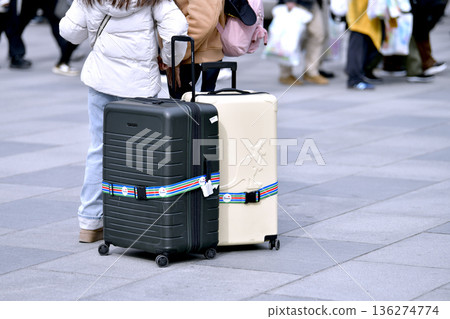 Tokyo cityscape in Japan. Suitcases.... Tokyo Station Marunouchi Square bustling with foreign tourists Tokyo cityscape in Japan. Suitcases.... Tokyo Station Marunouchi Square bustling with foreign tourists 136274774