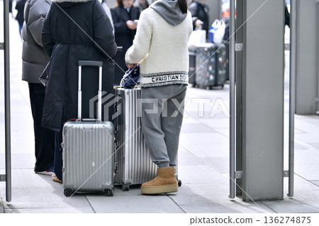 Tokyo cityscape in Japan. Suitcases.... Tokyo Station Marunouchi Square bustling with foreign tourists Tokyo cityscape in Japan. Suitcases.... Tokyo Station Marunouchi Square bustling with foreign tourists 136274875