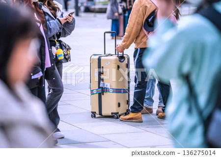 Tokyo cityscape in Japan. Suitcases.... Tokyo Station Marunouchi Square bustling with foreign tourists 136275014