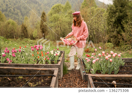 Woman holding tulip bouquet in mountain countryside 136275306