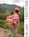 Woman holding tulips in mountain landscape 136275308
