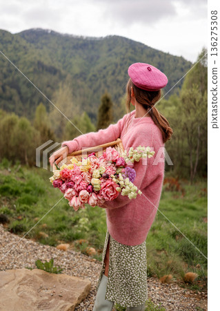 Woman holding tulips in mountain landscape 136275308