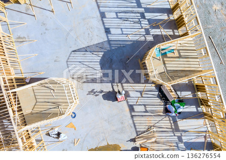 Workers are engaged in framing beams structures at construction site cast on built slab foundations 136276554