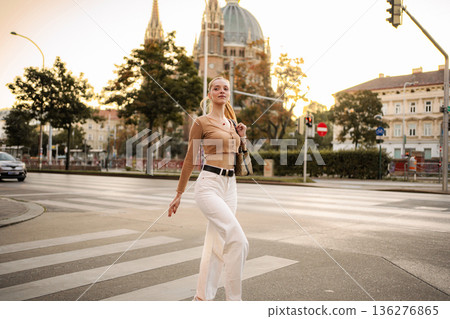 Young woman walking across street in Vienna Austria Young woman walking across street in Vienna Austria 136276865
