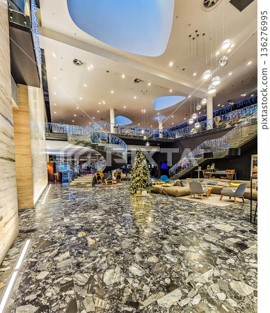 Luxurious lobby of the Clarion Congress Hotel in Ostrava, decorated for Christmas with a large tree. 136276995